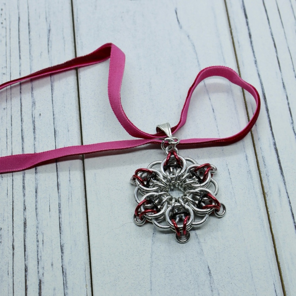 Stainless steel and red aluminium rings in a chain maille ‘star’ pendant